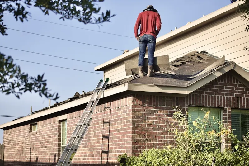 Professional roofer working on a residential roof in Ringfield